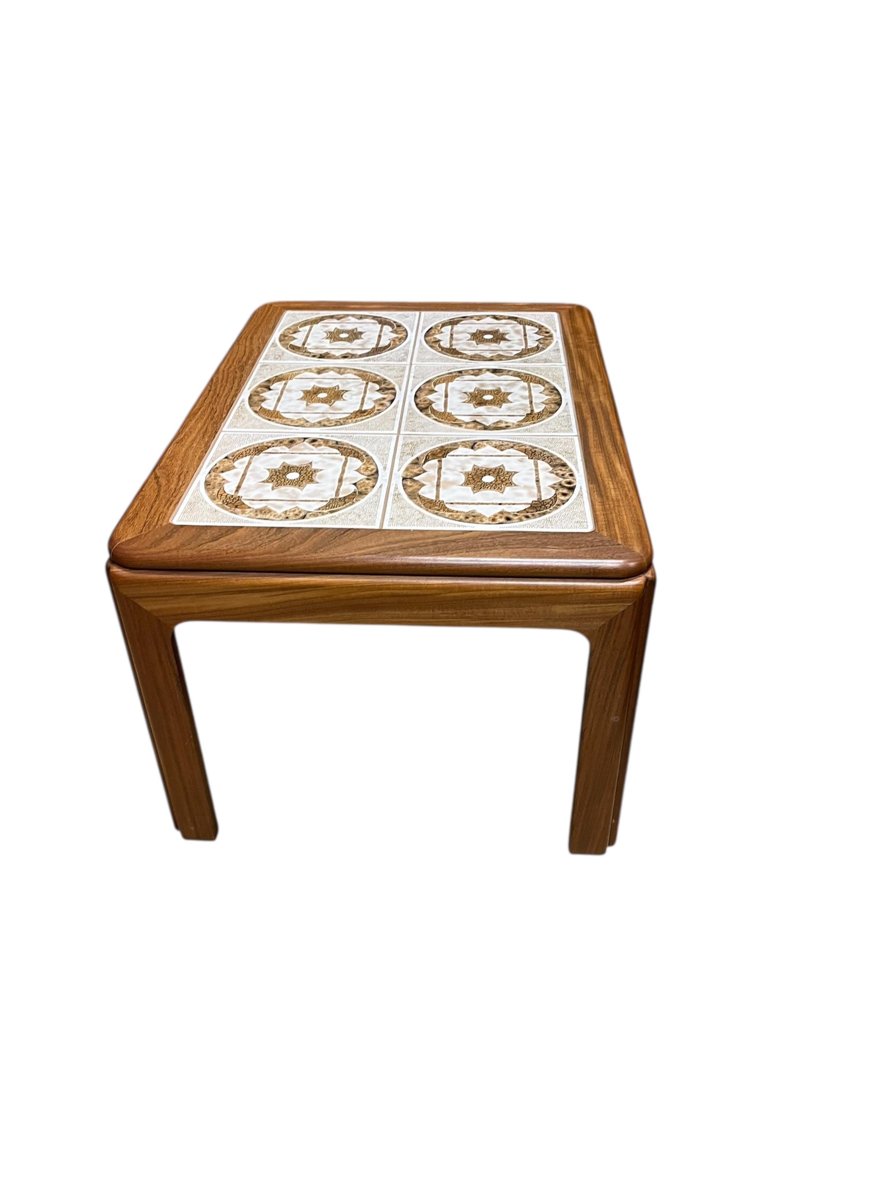 A mid century G Plan tile top teak coffee table and two matching occasional tables, larger width 134cm, depth 74cm, height 46cm